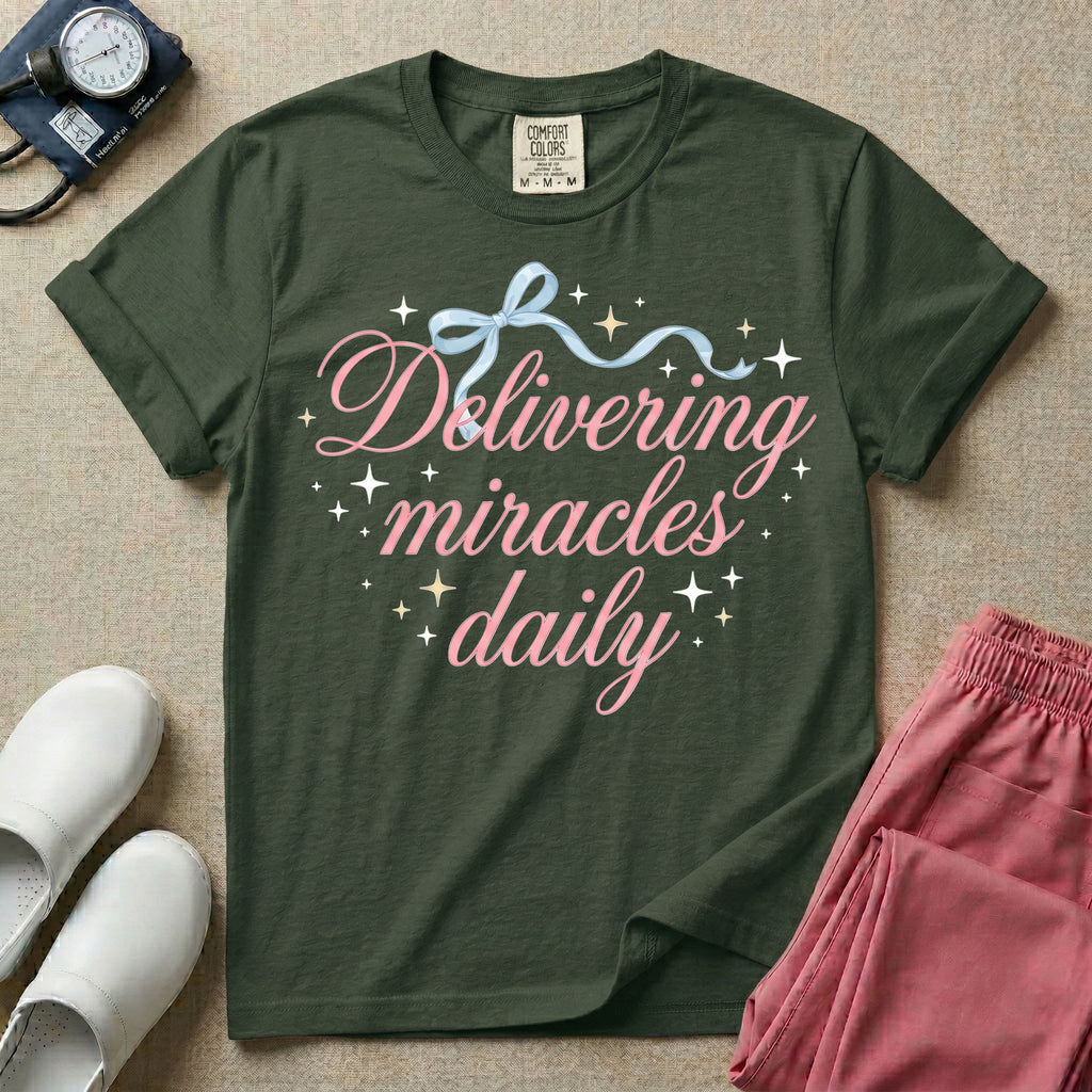 A graphic featuring the phrase "Delivering miracles daily" in elegant pink cursive script, topped with a delicate light blue ribbon bow and surrounded by sparkling stars, designed for labor and delivery, postpartum, and NICU nurses.