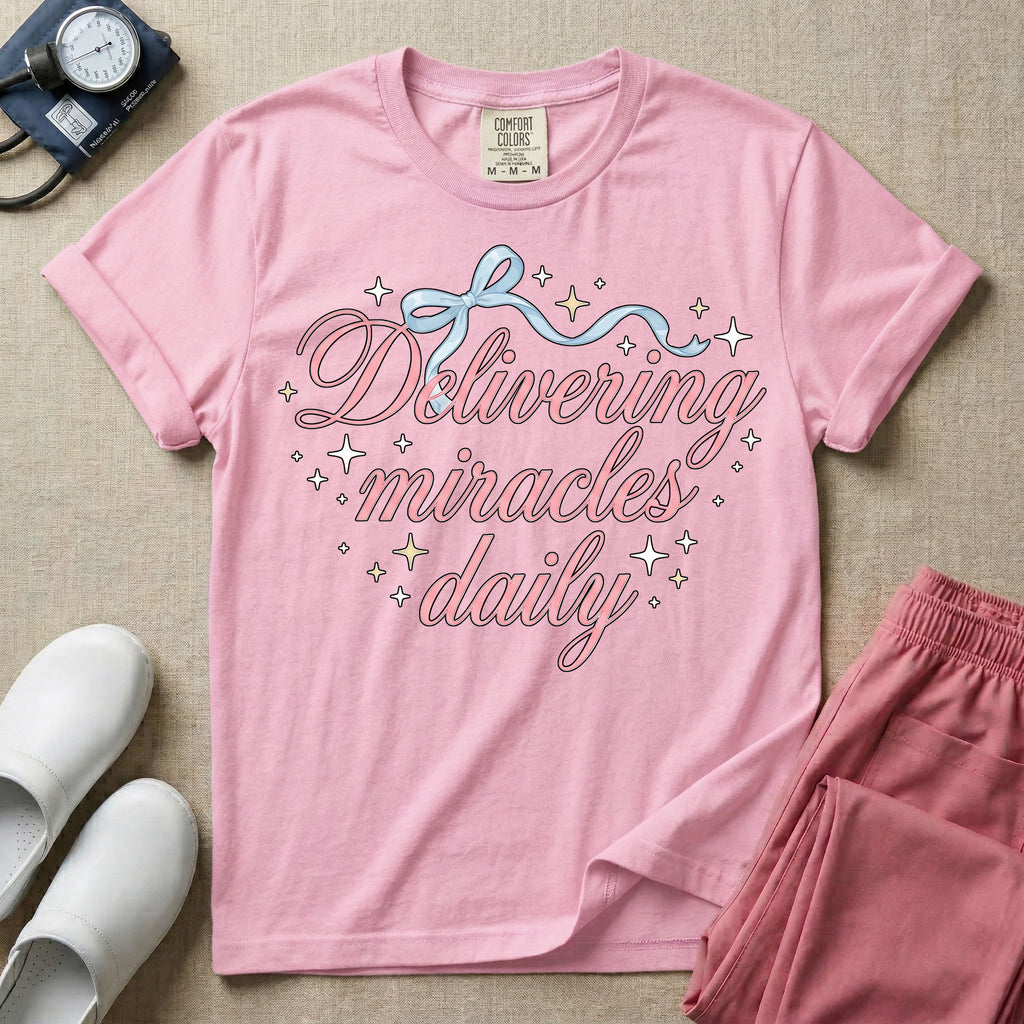 A graphic featuring the phrase "Delivering miracles daily" in elegant pink cursive script, topped with a delicate light blue ribbon bow and surrounded by sparkling stars, designed for labor and delivery, postpartum, and NICU nurses.
