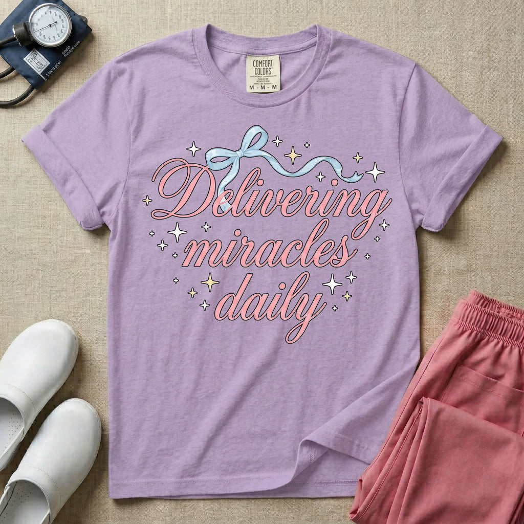 A graphic featuring the phrase "Delivering miracles daily" in elegant pink cursive script, topped with a delicate light blue ribbon bow and surrounded by sparkling stars, designed for labor and delivery, postpartum, and NICU nurses.