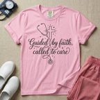 A graphic featuring a minimalist white line art stethoscope that loops into the shape of a cross, accompanied by the phrase "Guided by faith, called to care" in an elegant cursive script surrounded by small stars, designed for nurses.