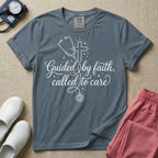 A graphic featuring a minimalist white line art stethoscope that loops into the shape of a cross, accompanied by the phrase "Guided by faith, called to care" in an elegant cursive script surrounded by small stars, designed for nurses.
