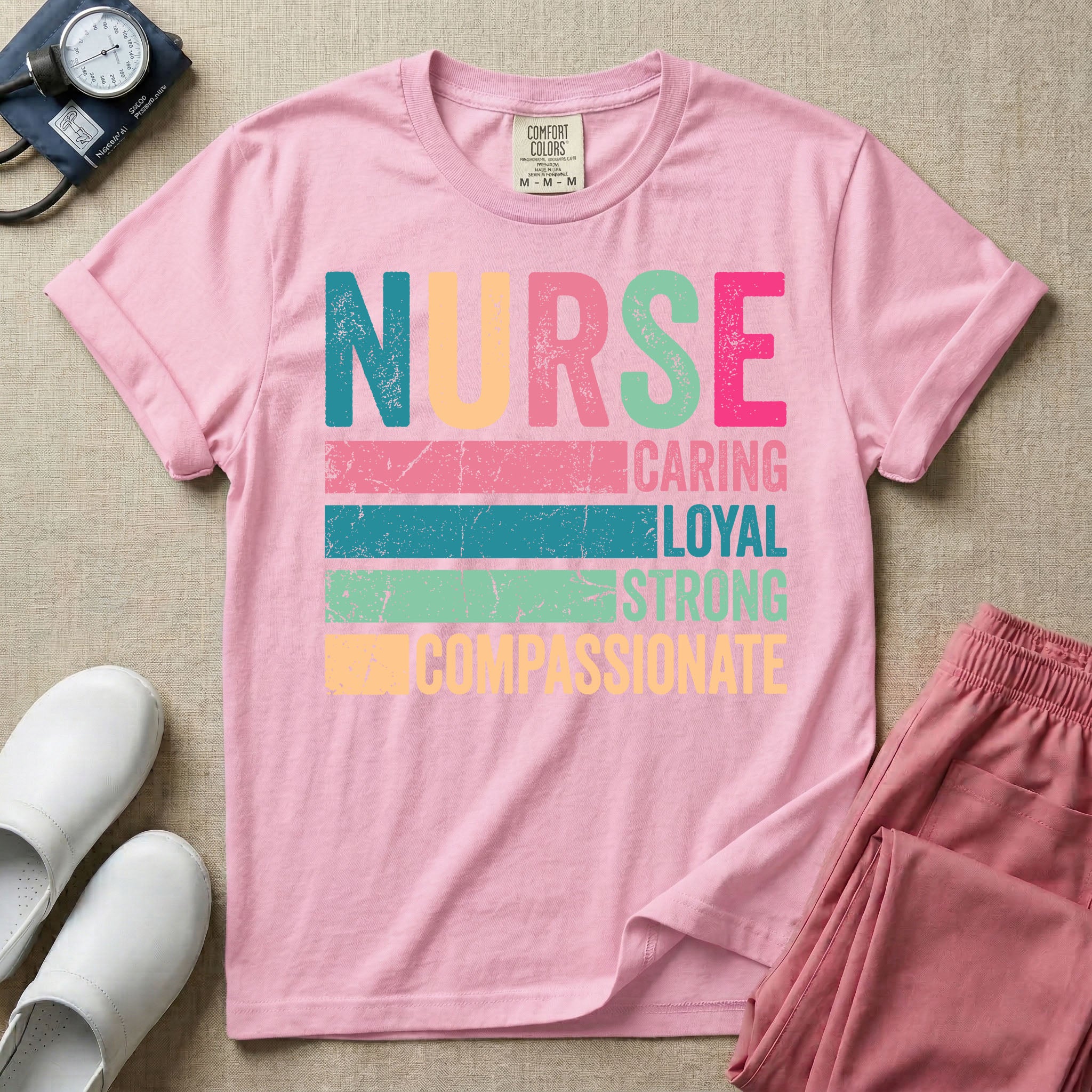 A retro graphic design for general nursing featuring the word NURSE in large, colorful distressed block letters above horizontal stripes reading CARING, LOYAL, STRONG, and COMPASSIONATE.