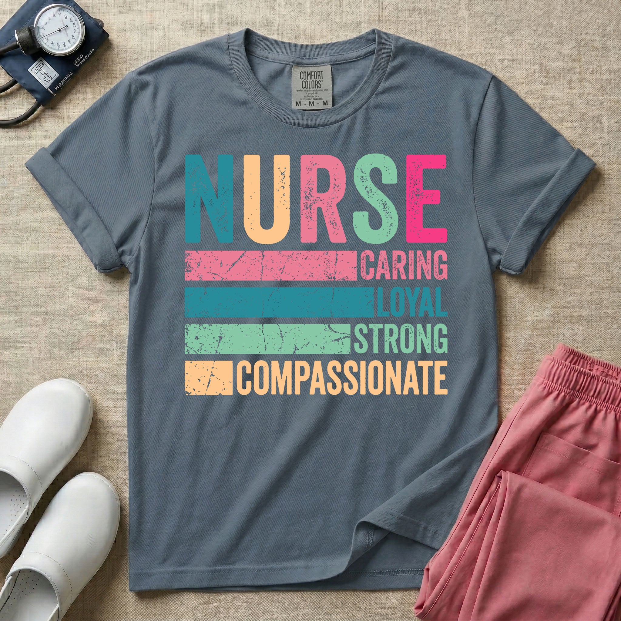 A retro graphic design for general nursing featuring the word NURSE in large, colorful distressed block letters above horizontal stripes reading CARING, LOYAL, STRONG, and COMPASSIONATE.