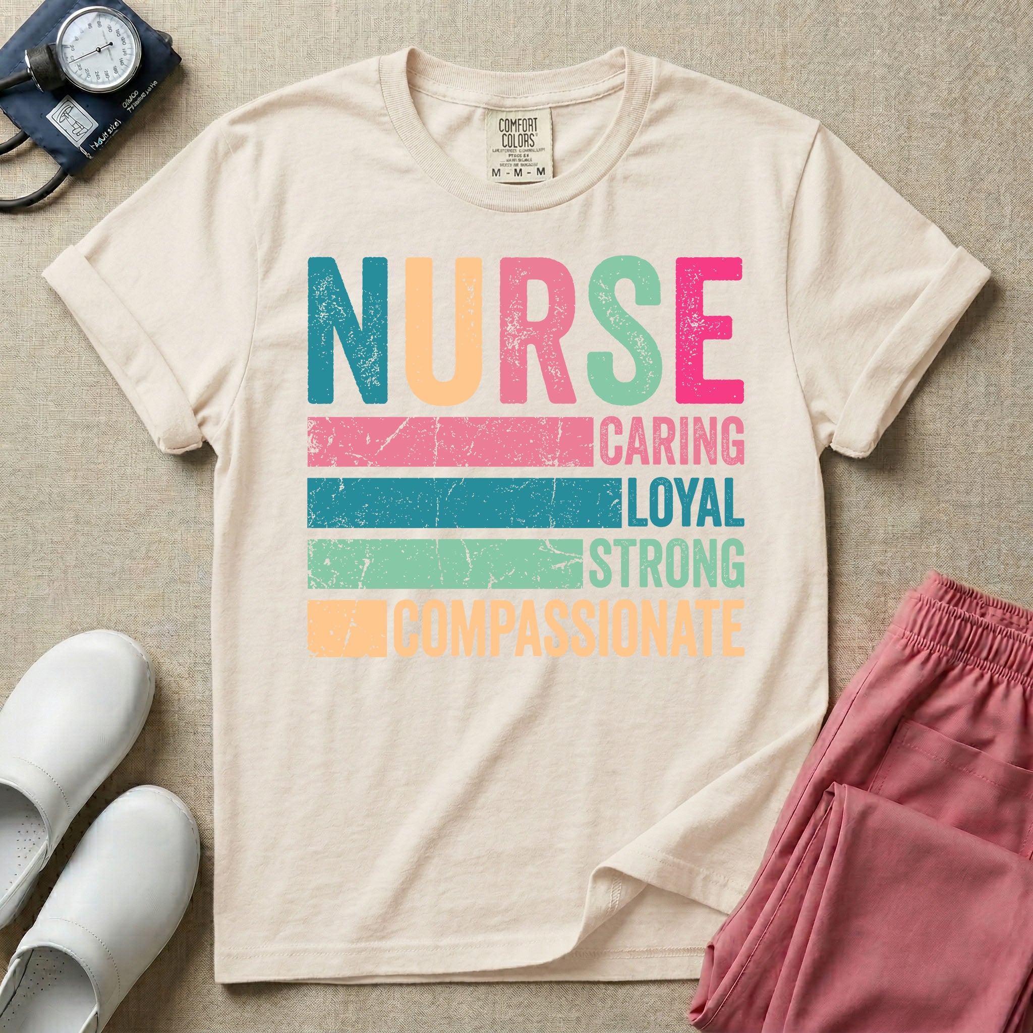 A retro graphic design for general nursing featuring the word NURSE in large, colorful distressed block letters above horizontal stripes reading CARING, LOYAL, STRONG, and COMPASSIONATE.
