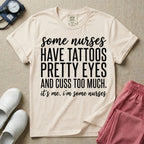 A funny graphic design for general nursing featuring white typography that reads some nurses HAVE TATTOOS PRETTY EYES AND CUSS TOO MUCH. it's me. i'm some nurses.