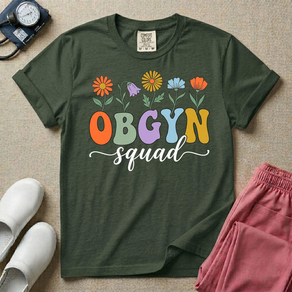 A retro floral graphic design for an OB-GYN unit featuring colorful retro flowers growing out of the letters OBGYN, with the word squad written below in a white cursive script.