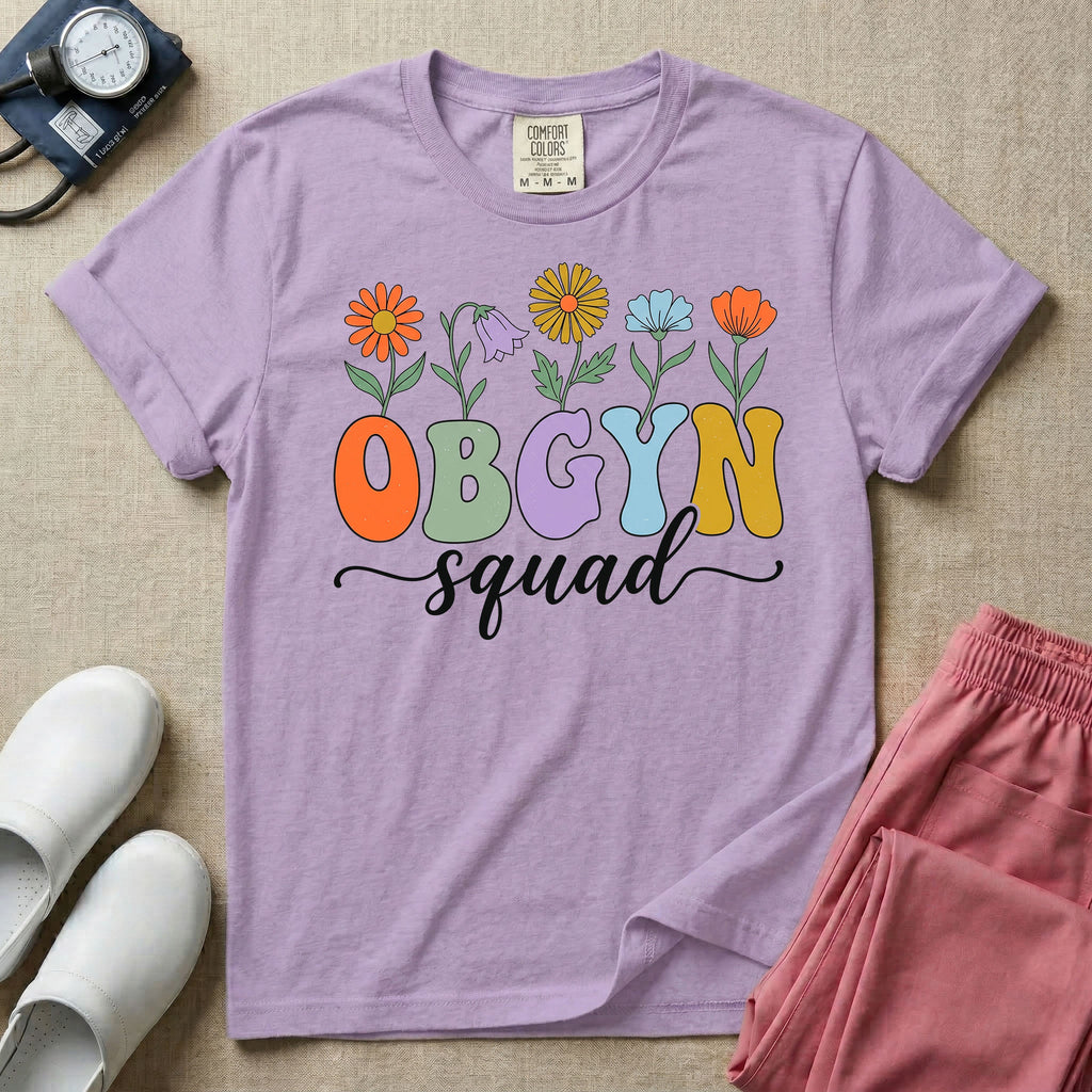 A retro floral graphic design for an OB-GYN unit featuring colorful retro flowers growing out of the letters OBGYN, with the word squad written below in a white cursive script.