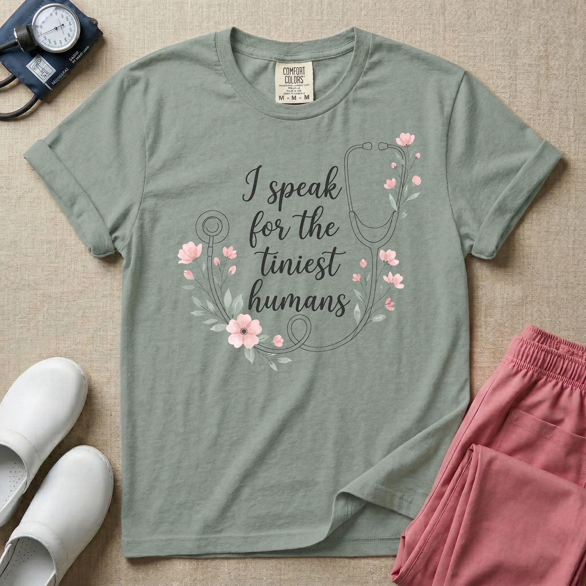 A boho floral graphic design featuring a delicate line-art stethoscope wrapped in soft pink flowers and green leaves, with the text I speak for the tiniest humans written in the center in an elegant script.