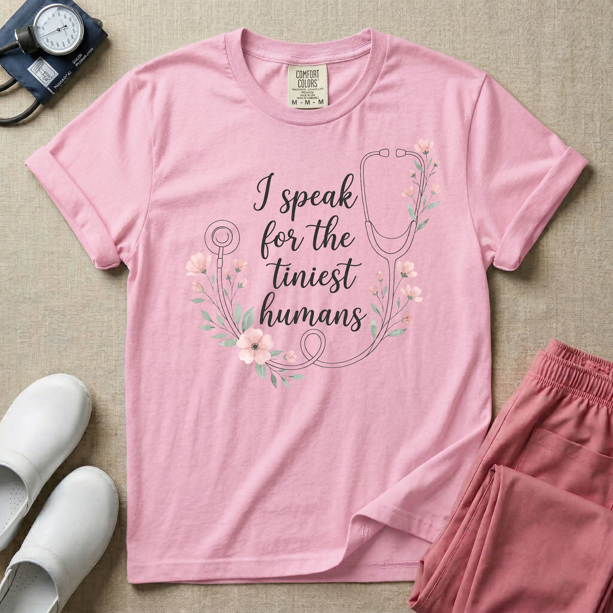 A boho floral graphic design featuring a delicate line-art stethoscope wrapped in soft pink flowers and green leaves, with the text I speak for the tiniest humans written in the center in an elegant script.
