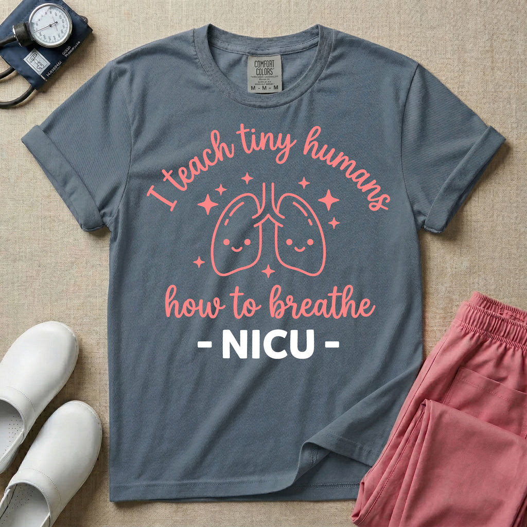 A cute graphic design for NICU nursing featuring pink illustrations of smiling lungs surrounded by little sparkles, with the text I teach tiny humans how to breathe above and NICU below.