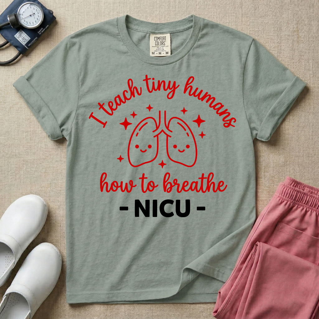 A cute graphic design for NICU nursing featuring pink illustrations of smiling lungs surrounded by little sparkles, with the text I teach tiny humans how to breathe above and NICU below.