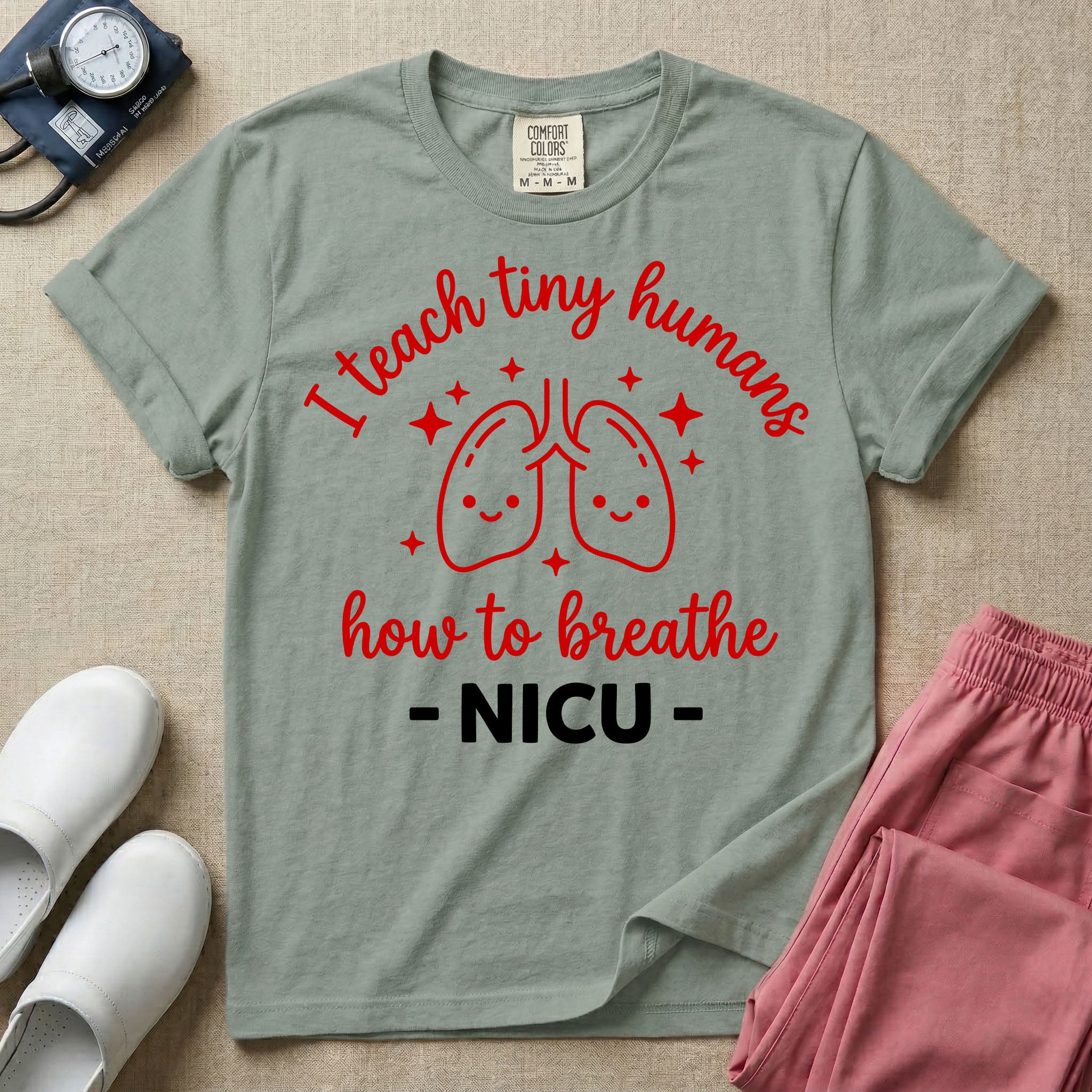 A cute graphic design for NICU nursing featuring pink illustrations of smiling lungs surrounded by little sparkles, with the text I teach tiny humans how to breathe above and NICU below.