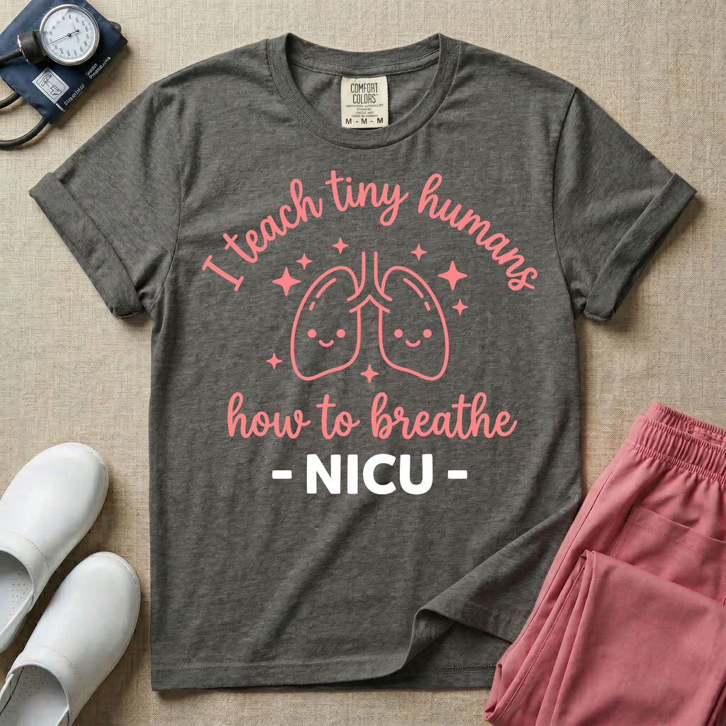 A cute graphic design for NICU nursing featuring pink illustrations of smiling lungs surrounded by little sparkles, with the text I teach tiny humans how to breathe above and NICU below.