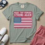 A patriotic graphic design for NICU nursing featuring the text MAKE TINY HUMANS STRONG AGAIN in white block letters against a distressed red background, positioned above a vintage American flag where the traditional stars have been replaced by rows of tiny white baby footprints.