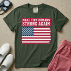 A patriotic graphic design for NICU nursing featuring the text MAKE TINY HUMANS STRONG AGAIN in white block letters against a distressed red background, positioned above a vintage American flag where the traditional stars have been replaced by rows of tiny white baby footprints.