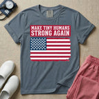 A patriotic graphic design for NICU nursing featuring the text MAKE TINY HUMANS STRONG AGAIN in white block letters against a distressed red background, positioned above a vintage American flag where the traditional stars have been replaced by rows of tiny white baby footprints.