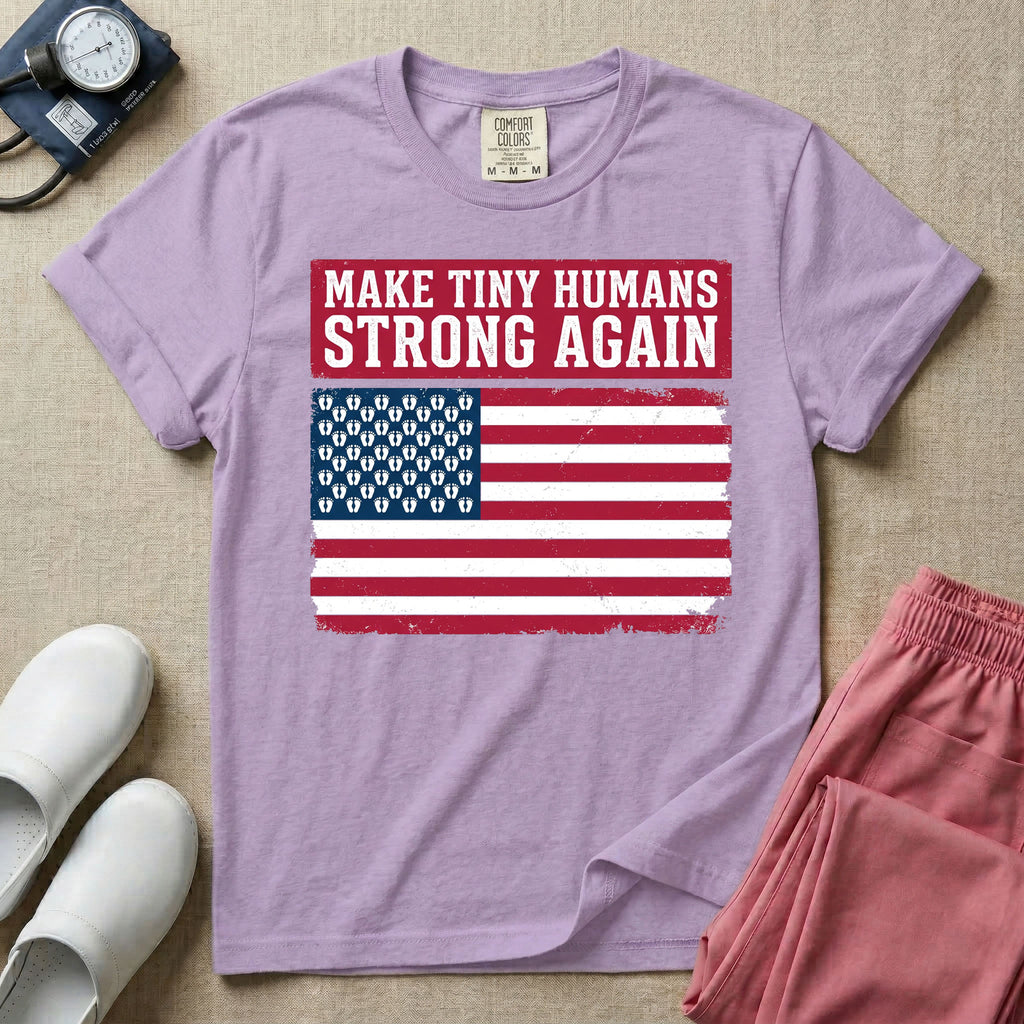 A patriotic graphic design for NICU nursing featuring the text MAKE TINY HUMANS STRONG AGAIN in white block letters against a distressed red background, positioned above a vintage American flag where the traditional stars have been replaced by rows of tiny white baby footprints.