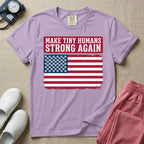 A patriotic graphic design for NICU nursing featuring the text MAKE TINY HUMANS STRONG AGAIN in white block letters against a distressed red background, positioned above a vintage American flag where the traditional stars have been replaced by rows of tiny white baby footprints.