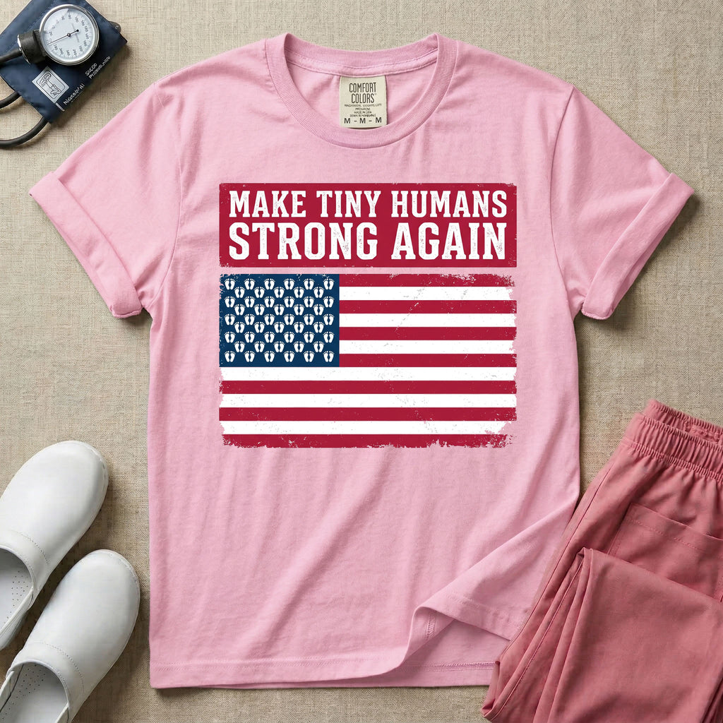 A patriotic graphic design for NICU nursing featuring the text MAKE TINY HUMANS STRONG AGAIN in white block letters against a distressed red background, positioned above a vintage American flag where the traditional stars have been replaced by rows of tiny white baby footprints.
