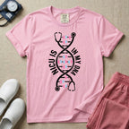 A graphic design for NICU nursing featuring a white DNA double helix structure intertwined with a stethoscope, where the rungs of the DNA strand are made of tiny pink and blue baby footprints, accompanied by the text NICU IS on the left and IN MY DNA on the right.