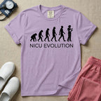 A funny minimalist graphic design for NICU nursing featuring a white silhouette illustration of human evolution progressing from an ape to a modern human, culminating in a nurse wearing scrubs holding a newborn baby, with the text NICU EVOLUTION written directly below.