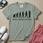 A funny minimalist graphic design for NICU nursing featuring a white silhouette illustration of human evolution progressing from an ape to a modern human, culminating in a nurse wearing scrubs holding a newborn baby, with the text NICU EVOLUTION written directly below.