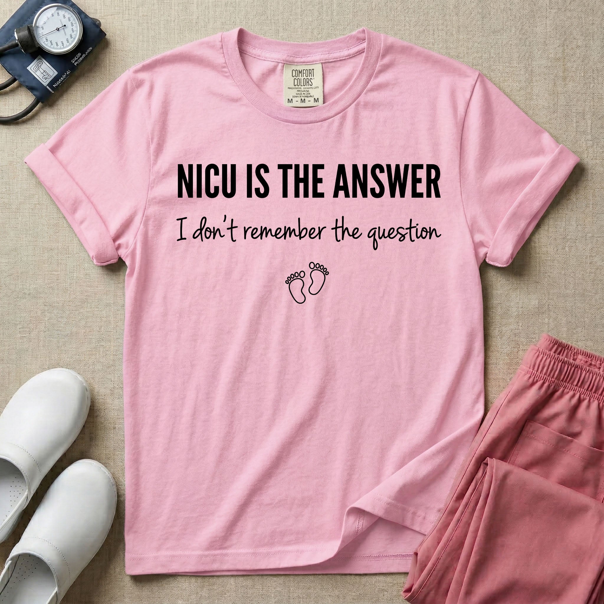 A funny neonatal intensive care unit nurse t-shirt featuring the text "NICU IS THE ANSWER I don't remember the question" with minimalist baby footprint graphics.