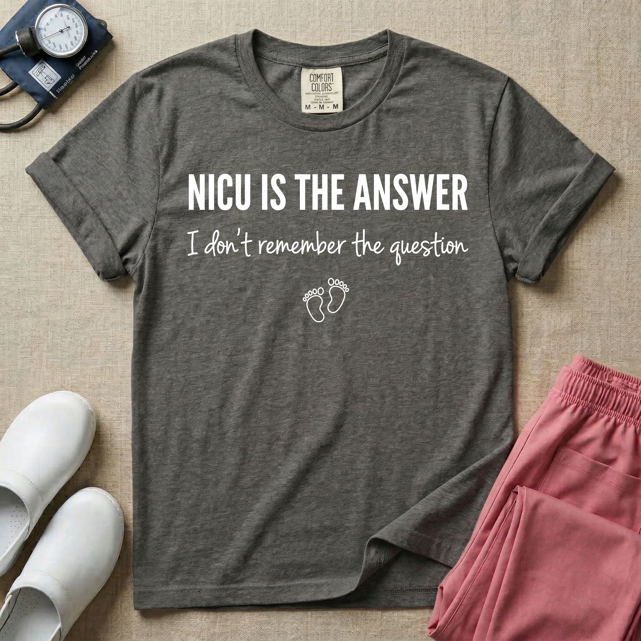 A funny neonatal intensive care unit nurse t-shirt featuring the text "NICU IS THE ANSWER I don't remember the question" with minimalist baby footprint graphics.