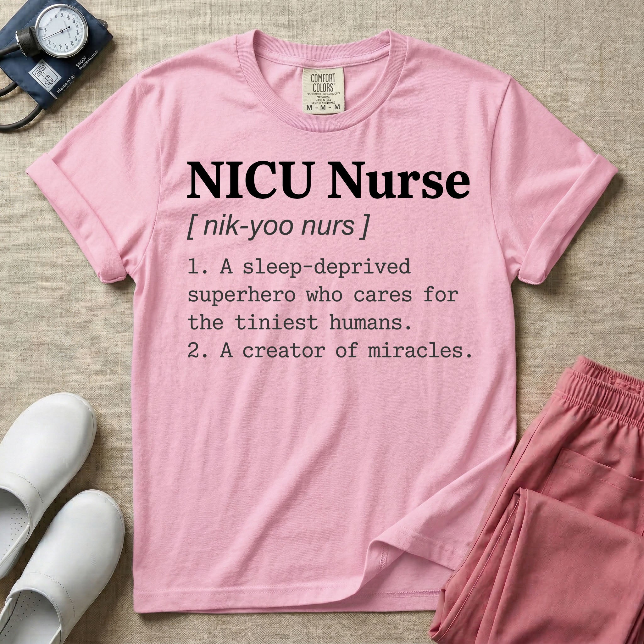 A minimalist neonatal intensive care unit t-shirt featuring a funny dictionary definition graphic that reads "NICU Nurse [ nik-yoo nurs ] 1. A sleep-deprived superhero who cares for the tiniest humans. 2. A creator of miracles."
