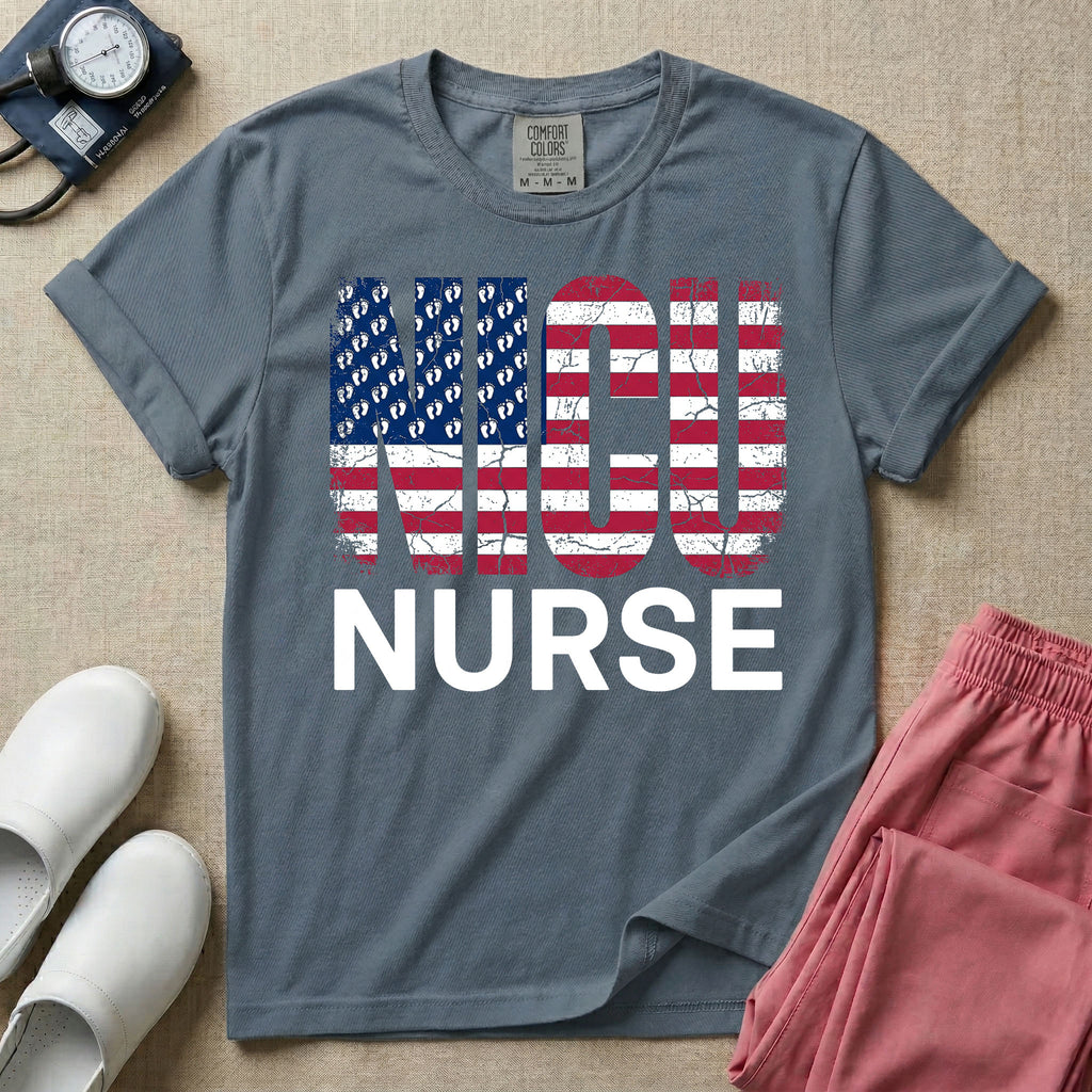A retro neonatal intensive care unit t-shirt featuring the text "NICU NURSE" with a distressed American flag graphic inside the letters, replacing the traditional stars with tiny white baby footprints.
