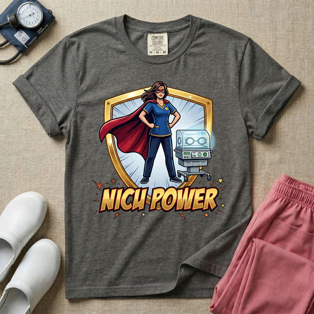 A comic book style neonatal intensive care unit t-shirt featuring an illustration of a confident female nurse wearing a red superhero cape and mask, standing next to an infant incubator inside a golden shield, with the bold text "NICU POWER" below.