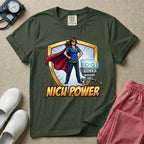 A comic book style neonatal intensive care unit t-shirt featuring an illustration of a confident female nurse wearing a red superhero cape and mask, standing next to an infant incubator inside a golden shield, with the bold text "NICU POWER" below.