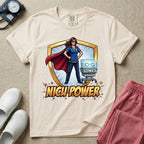 A comic book style neonatal intensive care unit t-shirt featuring an illustration of a confident female nurse wearing a red superhero cape and mask, standing next to an infant incubator inside a golden shield, with the bold text "NICU POWER" below.