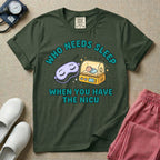 A funny neonatal intensive care unit t-shirt featuring an illustration of a purple sleep mask with Zs next to a yellow infant incubator with a baby inside, surrounded by the text "WHO NEEDS SLEEP WHEN YOU HAVE THE NICU" in a bold teal font.