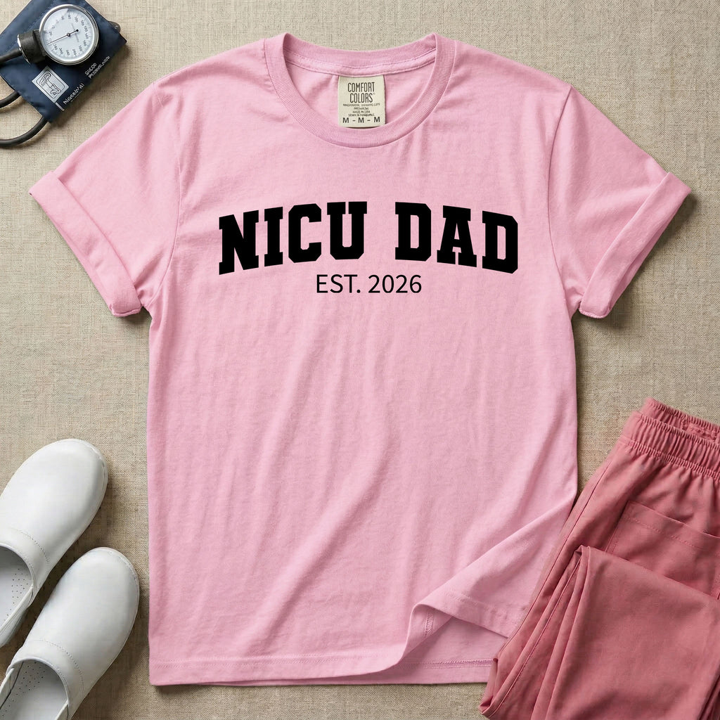 A minimalist personalized t-shirt for the NICU unit featuring bold white collegiate varsity lettering that reads NICU DAD arched over the text EST. 2026.