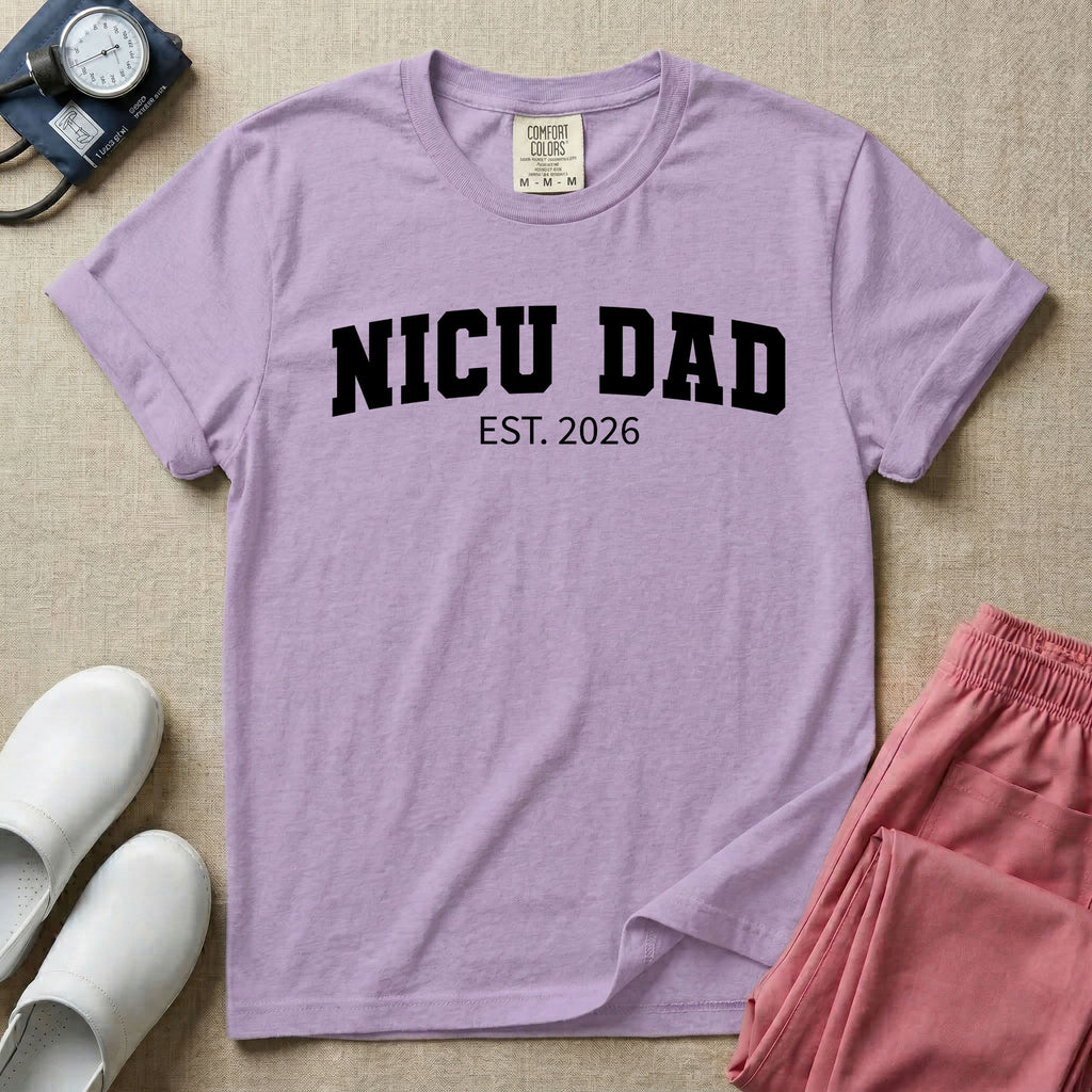 A minimalist personalized t-shirt for the NICU unit featuring bold white collegiate varsity lettering that reads NICU DAD arched over the text EST. 2026.