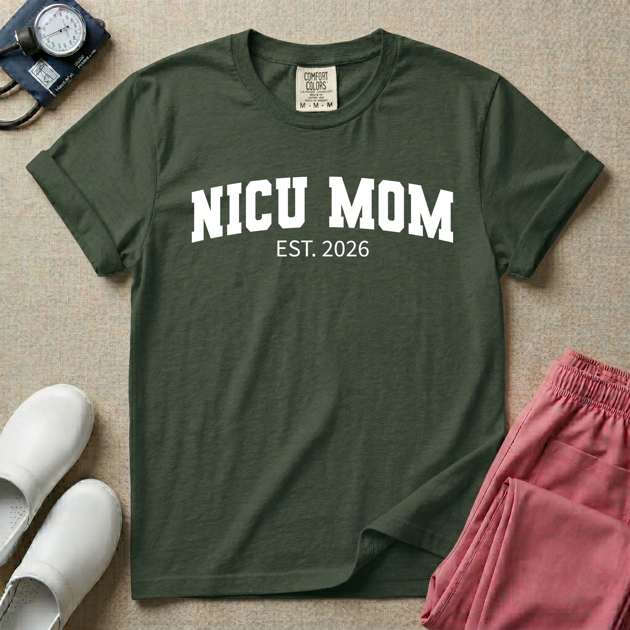 A minimalist personalized t-shirt for the NICU unit featuring bold white collegiate varsity lettering that reads NICU MOM arched over the text EST. 2026.