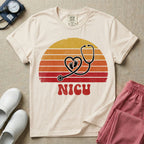 Retro vintage graphic featuring a distressed sunset background with a heart-shaped stethoscope enclosing tiny baby footprints above the bold text NICU.