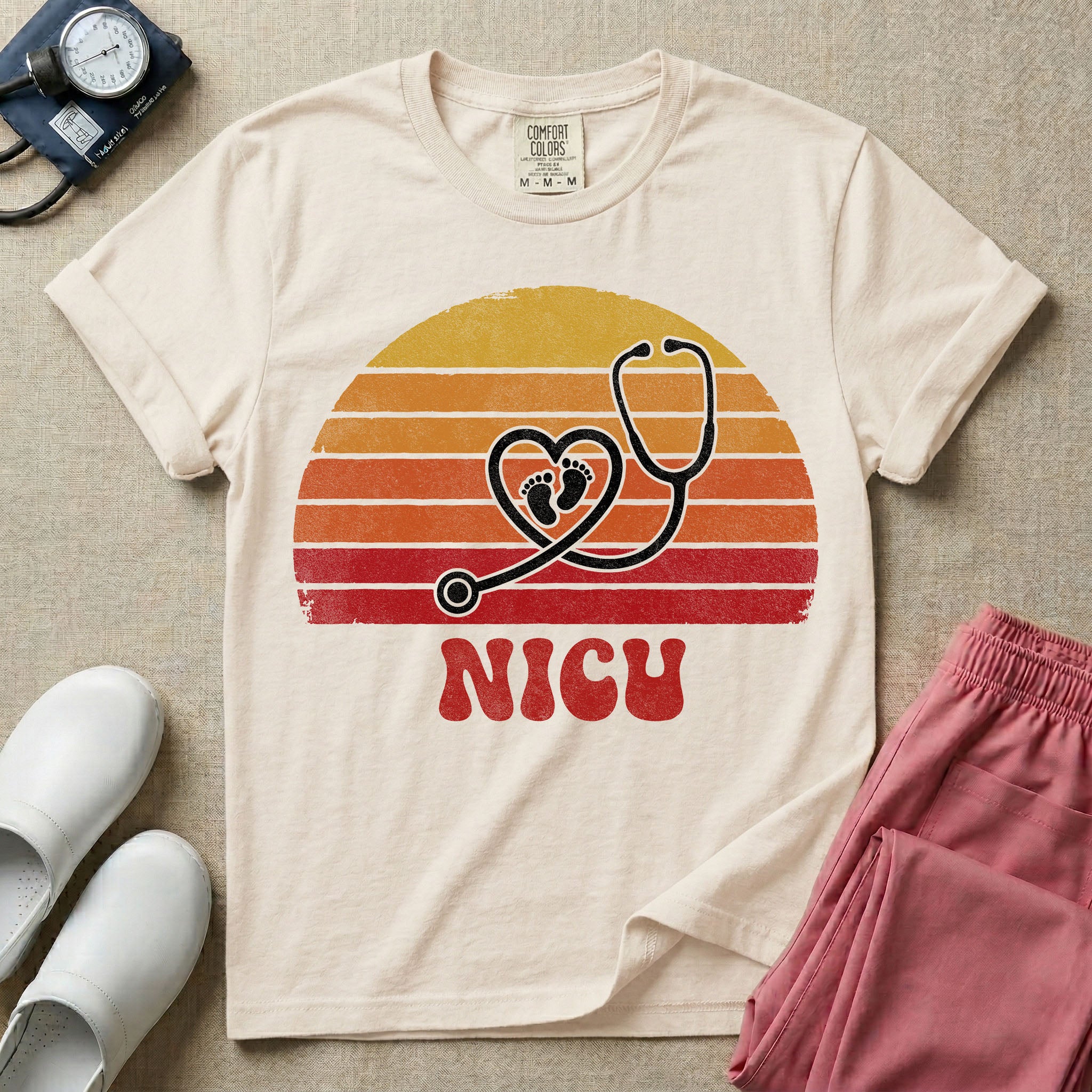 Retro vintage graphic featuring a distressed sunset background with a heart-shaped stethoscope enclosing tiny baby footprints above the bold text NICU.