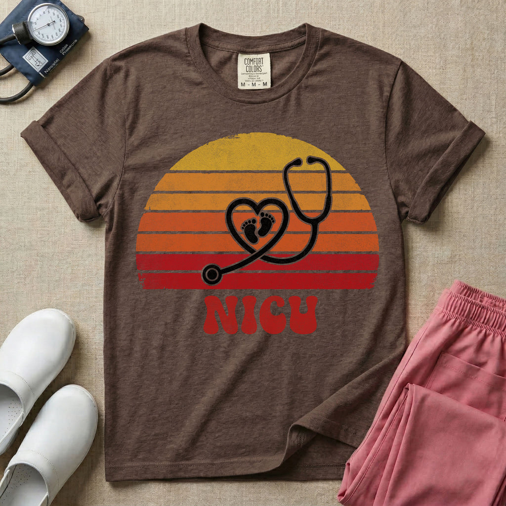 Retro vintage graphic featuring a distressed sunset background with a heart-shaped stethoscope enclosing tiny baby footprints above the bold text NICU.