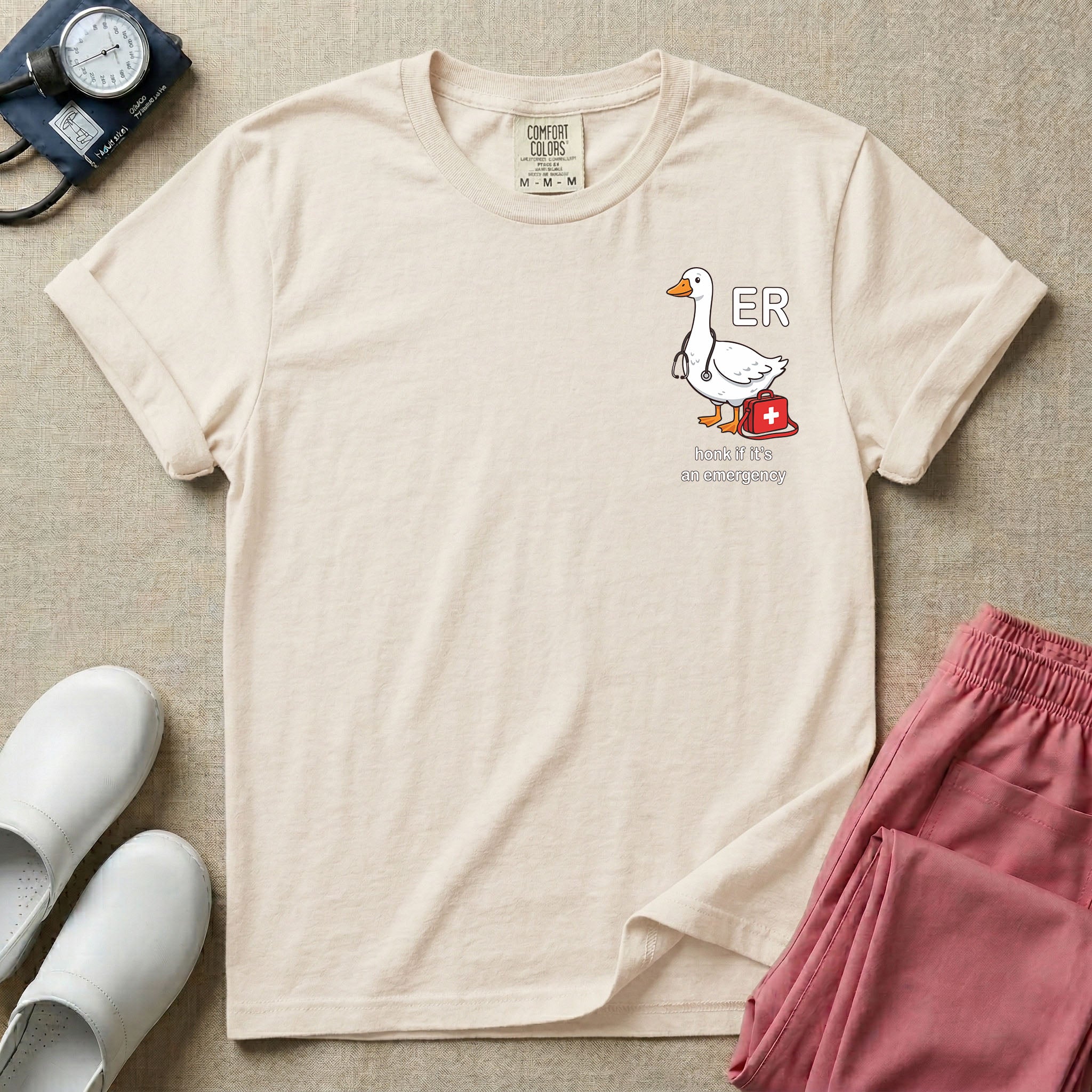 Cute cartoon goose wearing a stethoscope next to a red medical kit with ER text and the funny phrase honk if it's an emergency for emergency room nurses.