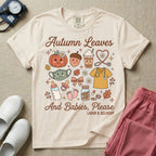 Cute retro Labor and Delivery nurse design featuring the text Autumn Leaves And Babies Please surrounded by a smiling pumpkin, iced coffee cup, heart-shaped stethoscope, scrub top, baby bottle, pacifier, and autumn leaves.