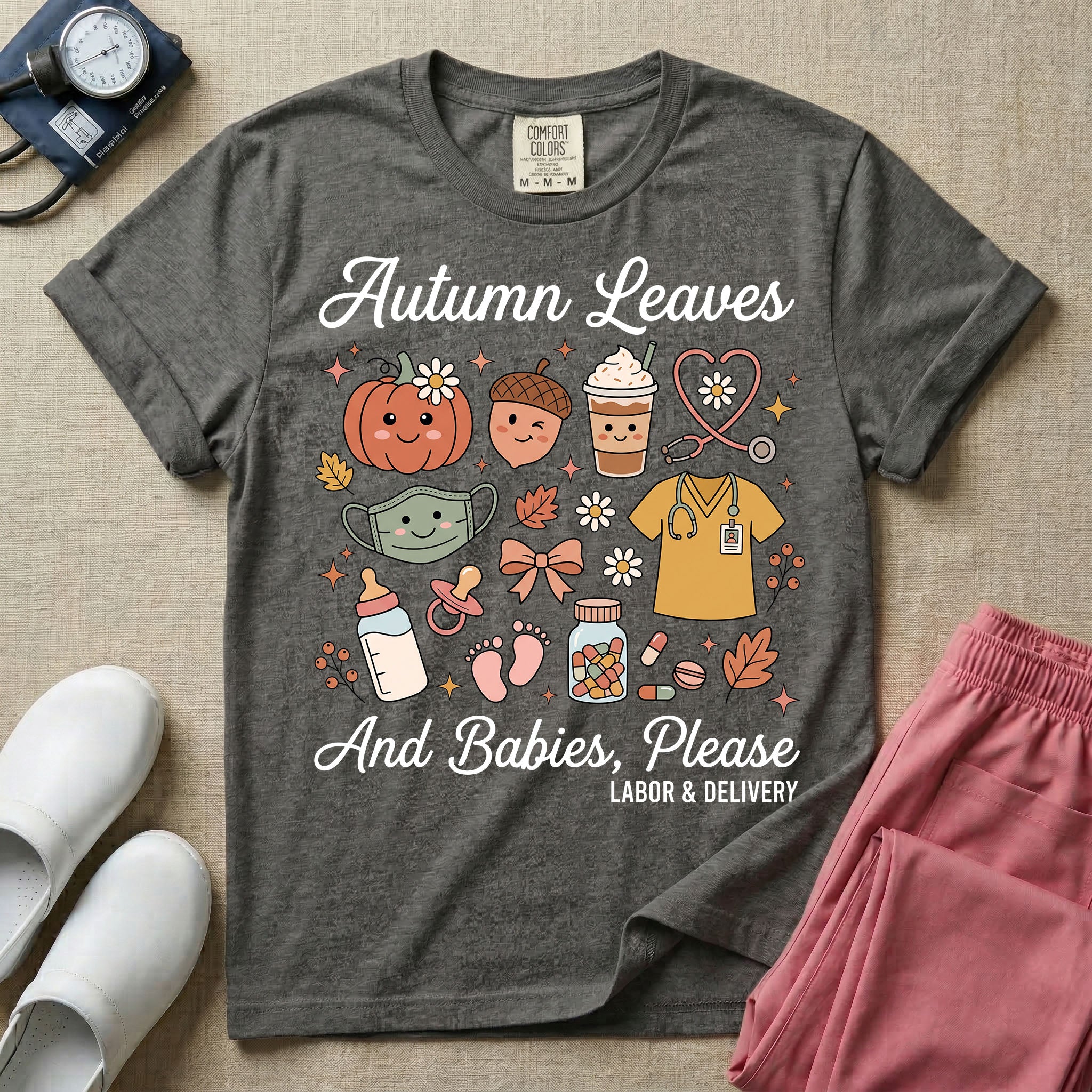 Cute retro Labor and Delivery nurse design featuring the text Autumn Leaves And Babies Please surrounded by a smiling pumpkin, iced coffee cup, heart-shaped stethoscope, scrub top, baby bottle, pacifier, and autumn leaves.