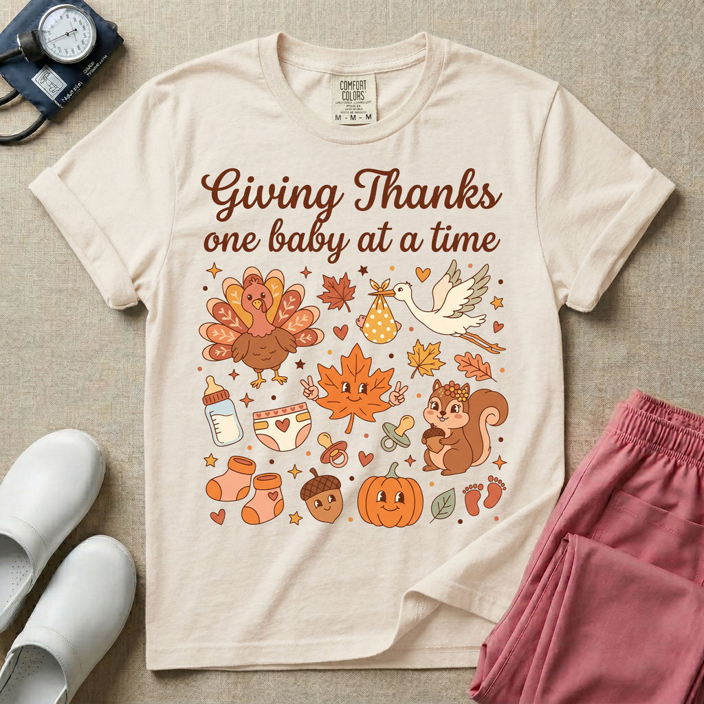 Retro Labor and Delivery and NICU nurse Thanksgiving design reading Giving Thanks One Baby At A Time surrounded by a cute turkey, baby delivery stork, smiling maple leaf, squirrel, pumpkin, baby bottle, booties, and autumn leaves.