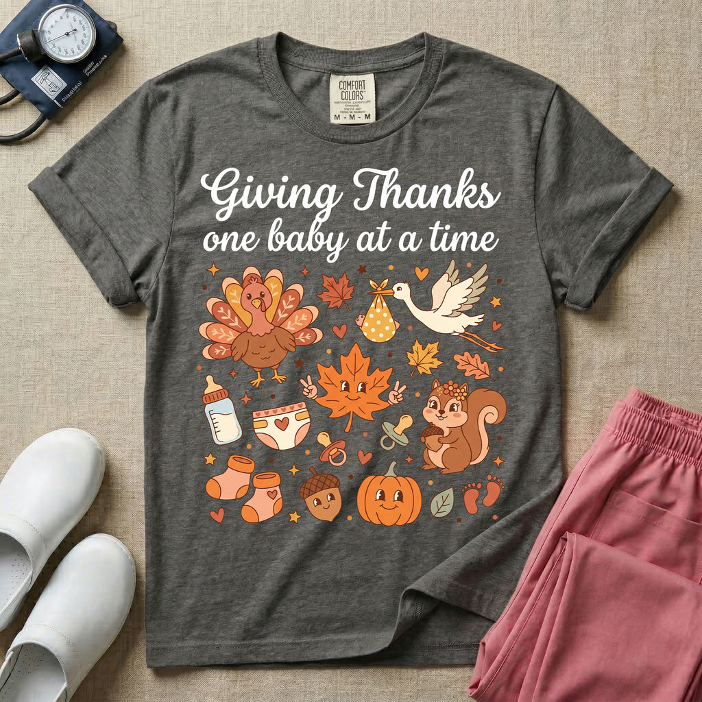 Retro Labor and Delivery and NICU nurse Thanksgiving design reading Giving Thanks One Baby At A Time surrounded by a cute turkey, baby delivery stork, smiling maple leaf, squirrel, pumpkin, baby bottle, booties, and autumn leaves.