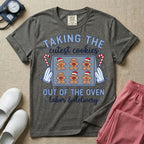 Christmas Labor and Delivery nurse design featuring the text Taking The Cutest Cookies Out Of The Oven surrounded by a baking sheet of gingerbread baby cookies in Santa hats, oven mitts, candy canes, and script text reading labor and delivery.