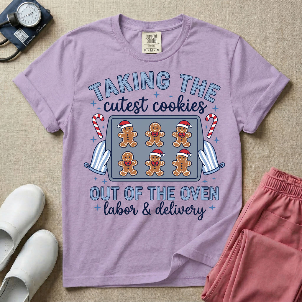 Christmas Labor and Delivery nurse design featuring the text Taking The Cutest Cookies Out Of The Oven surrounded by a baking sheet of gingerbread baby cookies in Santa hats, oven mitts, candy canes, and script text reading labor and delivery.