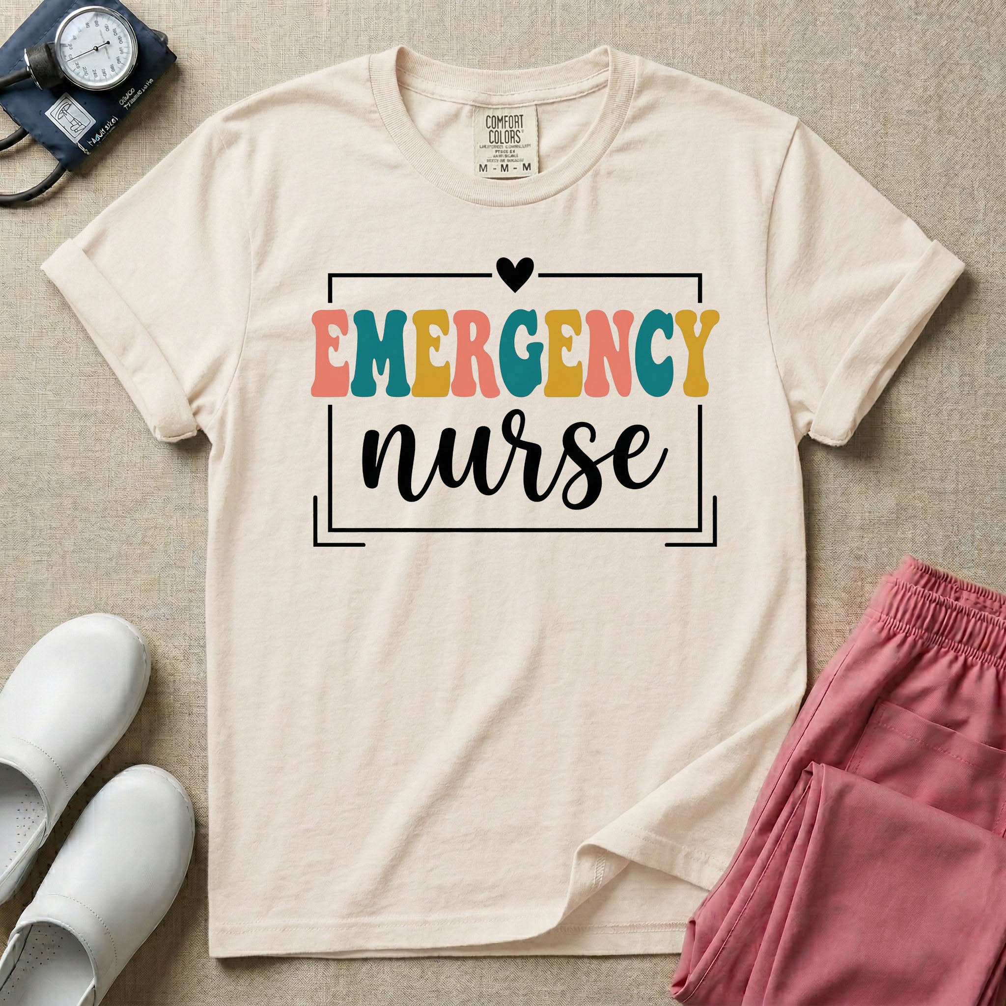 Retro Emergency Room nurse design featuring groovy multi-color block lettering spelling Emergency and white script text reading nurse within a minimalist heart-accented frame.
