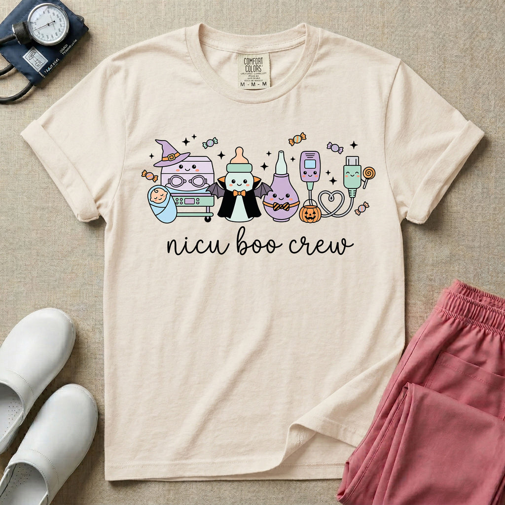 Cute Halloween NICU nurse graphic featuring kawaii medical equipment in costumes including an incubator wearing a witch hat, a baby bottle dressed as a vampire, a bulb syringe, and monitor sensors with candy above cursive text reading nicu boo crew.