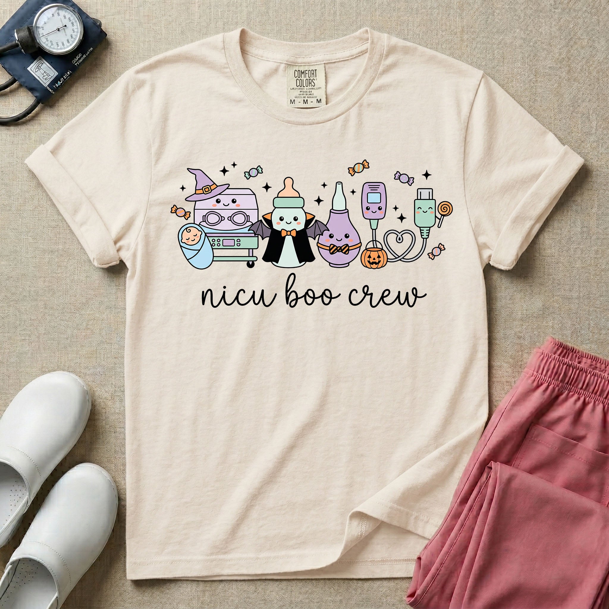 Cute Halloween NICU nurse graphic featuring kawaii medical equipment in costumes including an incubator wearing a witch hat, a baby bottle dressed as a vampire, a bulb syringe, and monitor sensors with candy above cursive text reading nicu boo crew.